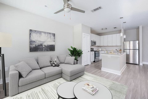 an open living room and kitchen with a couch and a table